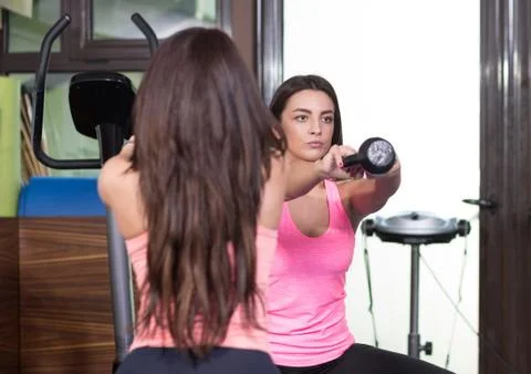 Two women front view exercise kettle bell Stock Photos