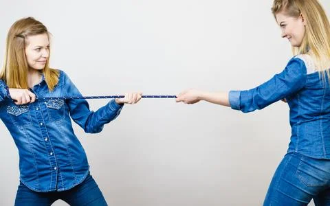 Two women having fun pulling rope Stock Photos