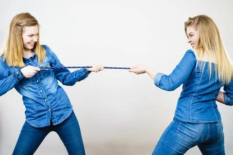 Two women having fun pulling rope Stock Photos
