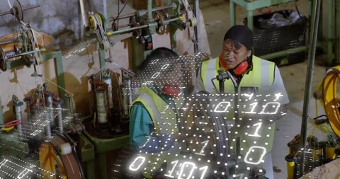 Two women inspecting cable winding machine at plant initiating binary overlay Stock Footage 312897151