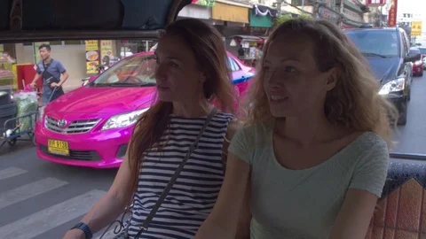 Two women interacting with each other while travelling in rickshaw Stock Footage 75293336