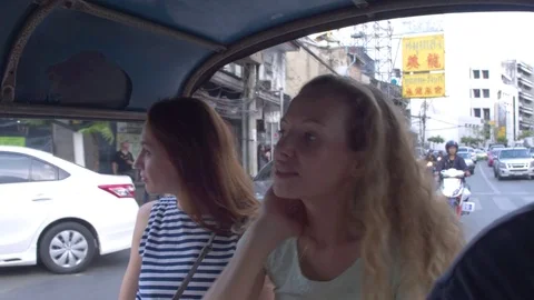 Two women interacting with each other while travelling in rickshaw Stock Footage 75293372