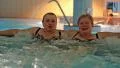 Two women in jacuzzi inside big water park HD Footage