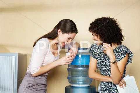 Two Women Laughing By Water Cooler
