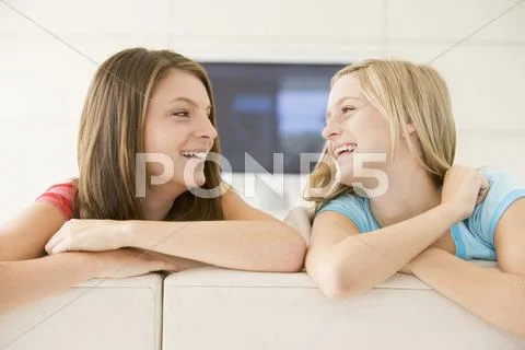 Two women in living room smiling Stock-Fotos