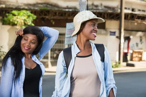 Two women looking while walking on the streets Photos