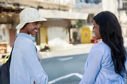 Two women looking while walking on the streets Photos