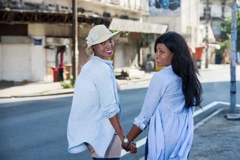 Two women looking while walking on the streets Photos