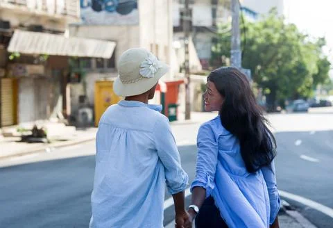 Two women looking while walking on the streets Photos
