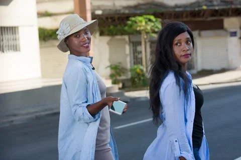 Two women looking while walking on the streets Photos