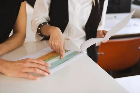Two women in office checking documents Stock Photos