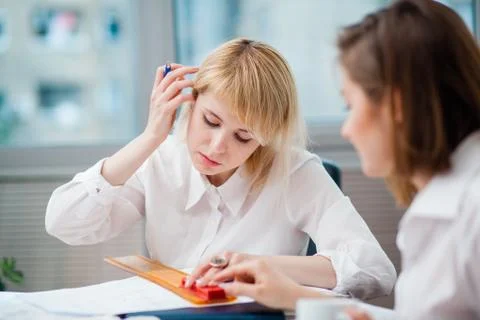 Two women in office working on a computer Stock Photos