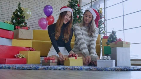 Two women open gift boxes together in Christmas festival. Stock Footage 120103609