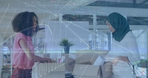 Two women opening boxes and packing, photographing products for shipping while Stock Footage 331833195