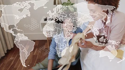 Two women packing open suitcase in bedroom, planning travel and world-map Stock Footage 333318414
