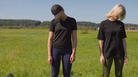 Two women performing neck stretching exercises outdoors Видео 331517853