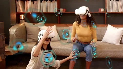 Two women placing white VR headsets, calling up blue icons, exploring virtual Stock Footage 333837883