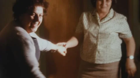 Two women playfully dancing together at home in 1968 Video stock 326892725
