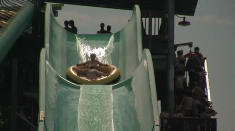 Two Women Plunging Down Fast Water Park Slide in a Tube Video stock 24691110
