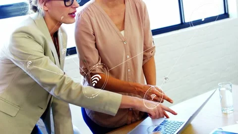 Two women pointing at laptop, starting overlay while peer pressing keys Stock Footage 334322018