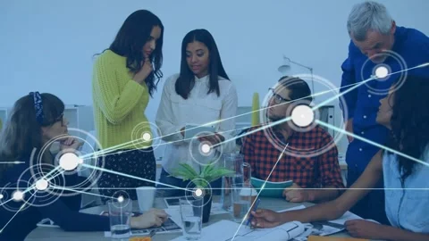 Two women presenting tablet, initiating network overlay mapping data flow across Stock Footage 330142829