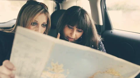 Two Women Reading Map in the car Stock Footage 43404071