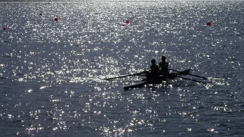 Two women rowing Stock Photos