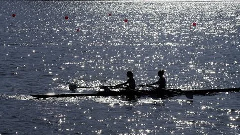 Two women rowing Stock Photos