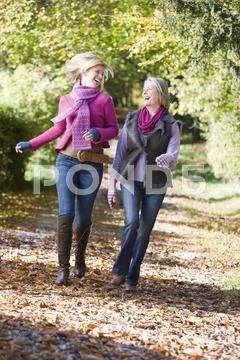 Two women running outdoors in park and smiling Stock-Fotos