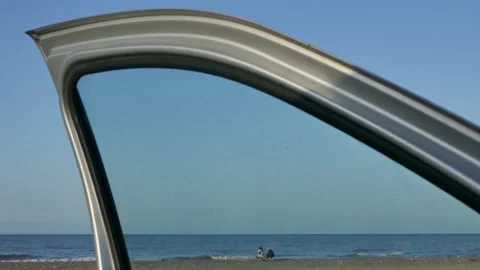 Two women by the sea framed through car window Stock Footage 318921653