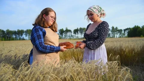 Two women sharing bread Stock Footage 254979580