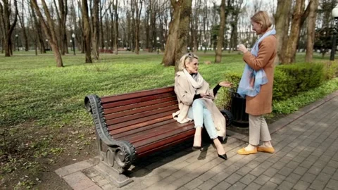 Two Women sitting on bench Stock Footage 165450433