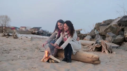 Two women sitting by the fire. BBQ picnic Video stock 75801473