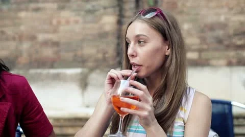 Two women sitting in the restaurant and chatting on cellphone, steadycam shot Stock Footage