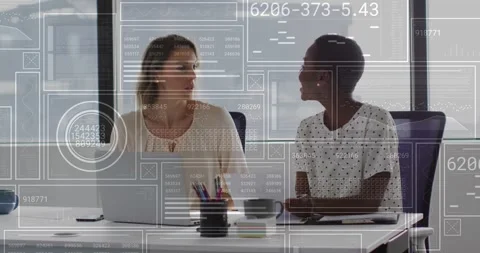 Two women sitting table framing laptop screen and explaining data causing Stock Footage 325963492
