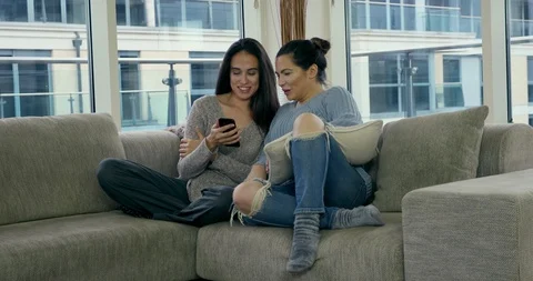 Two women on a sofa Stock Footage 129644038