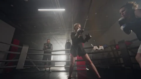 Two Women Sparring in Boxing Ring during Intense Training Stock Footage 340396401