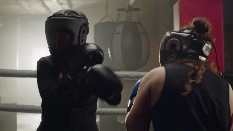 Two Women Sparring in Boxing Ring during Fitness Training Stock Footage 340404349
