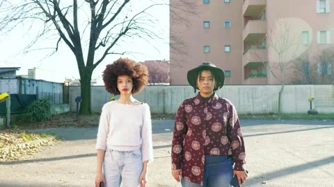 Two women standing in backyard looking at camera Stock Footage 154792887