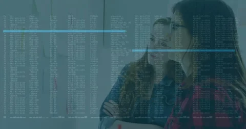 Two women studying sticky notes upon code overlay appearing and circling note in Stock Footage 313704314