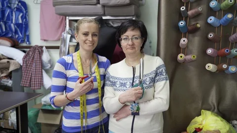 Two women tailors in the Studio close up with a pair of scissors Stock Footage 126940210