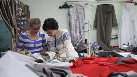 Two women tailors in the Studio working together Stock Footage 126975446
