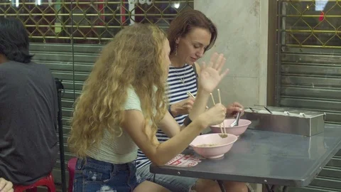 Two women talking while having soup in the restaurant 스톡 동영상 75293385