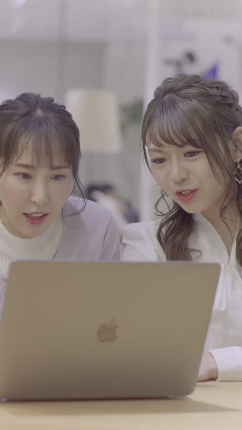 Two women talking while looking at a PC Stock-Footage 162241799