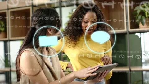 Two women tapping tablet and pointing causing overlay mail icon animating then Stock Footage 333950040