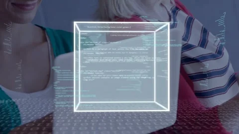 Two women tapping tablet, moving laptop, causing 3D cube rising with live code, Stock-Footage 335652127