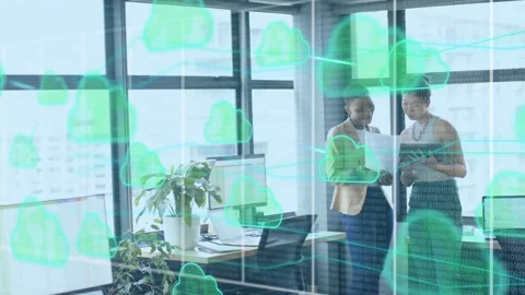 Two women team starting comparing paper tablet for cloud plan icons and streams Stock Footage 334322051