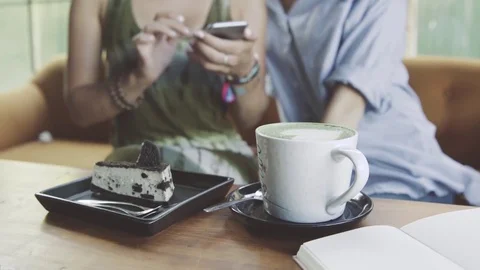 Two Women using digital tablet drinking coffee in cafe Stock Footage 73103662