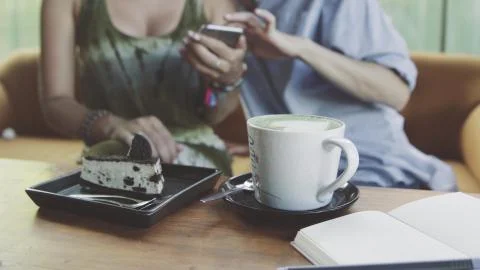 Two Women using digital tablet drinking coffee in cafe Stock Photos