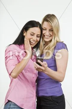 Two Women Using Handy, Laughing, Portrait